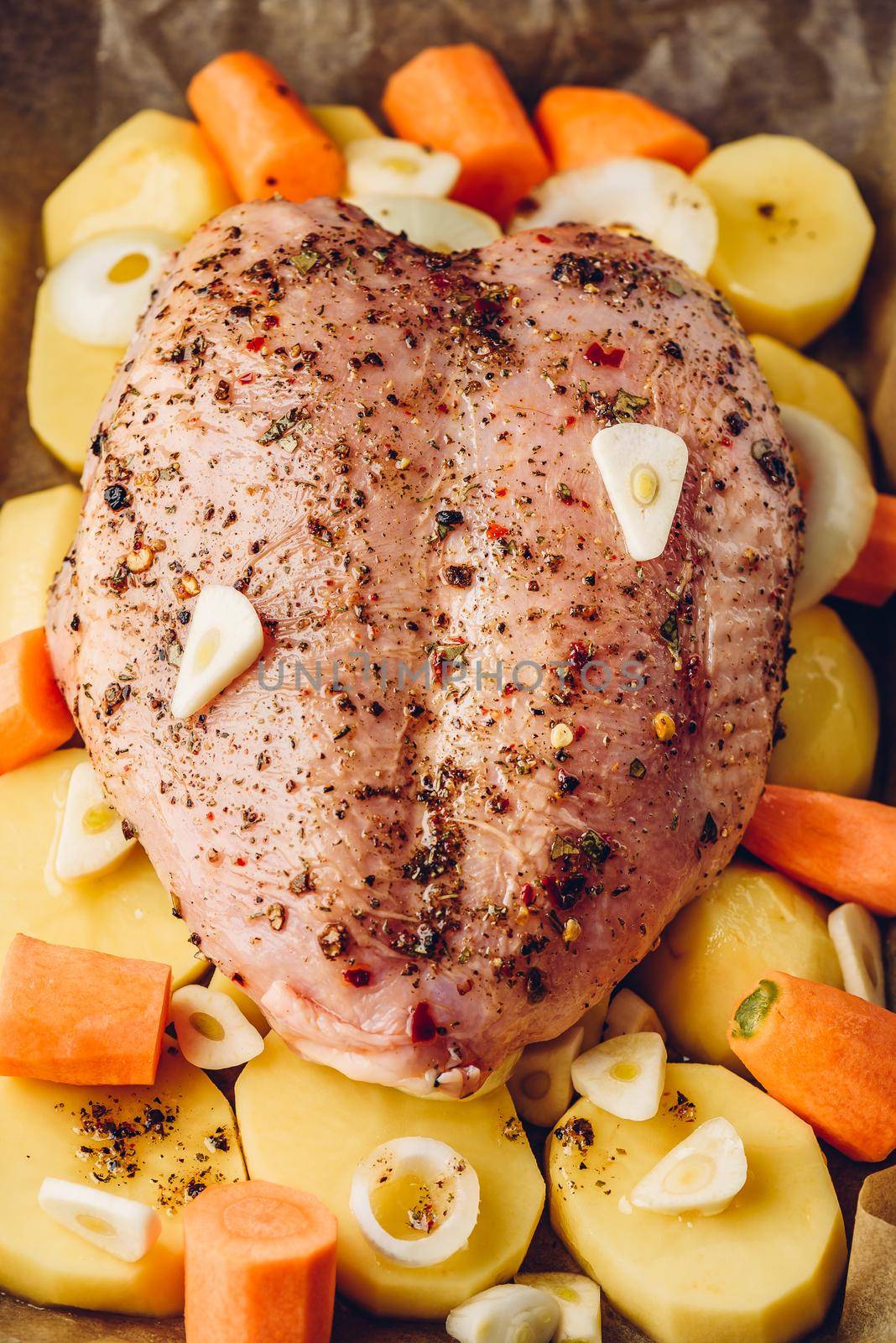 Seasoned chicken breast ready for roast in oven