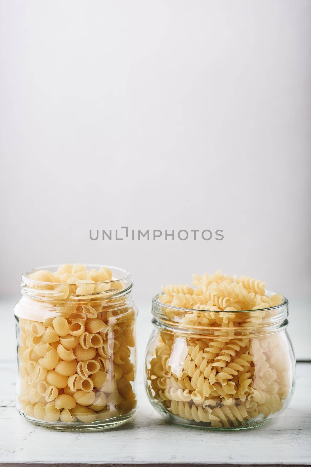 Two kinds of Italian whole wheat pasta in glass jars