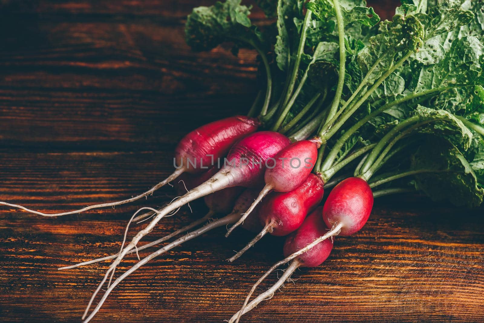 Bunch of fresh red radish on wooden table