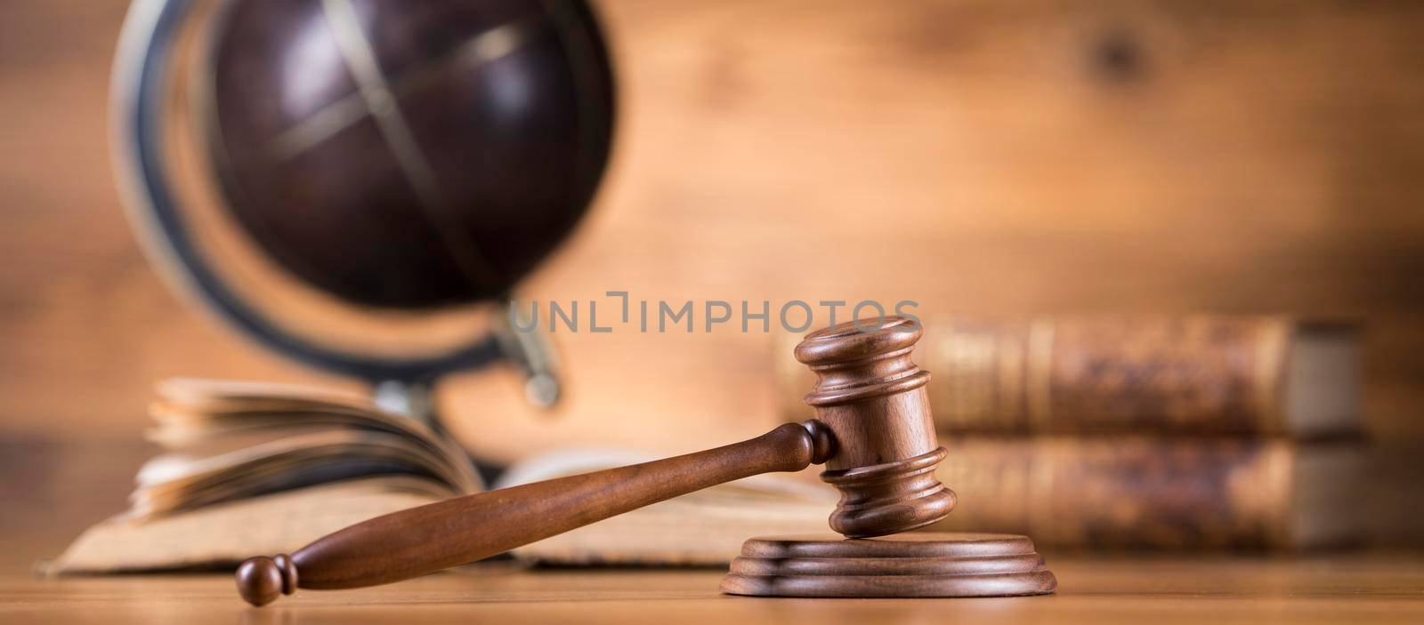 Law theme, mallet of judge, wooden gavel, globe background