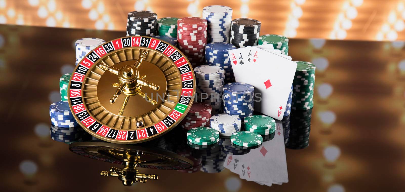 Poker Chips, Roulette wheel in motion, casino background  by JanPietruszka