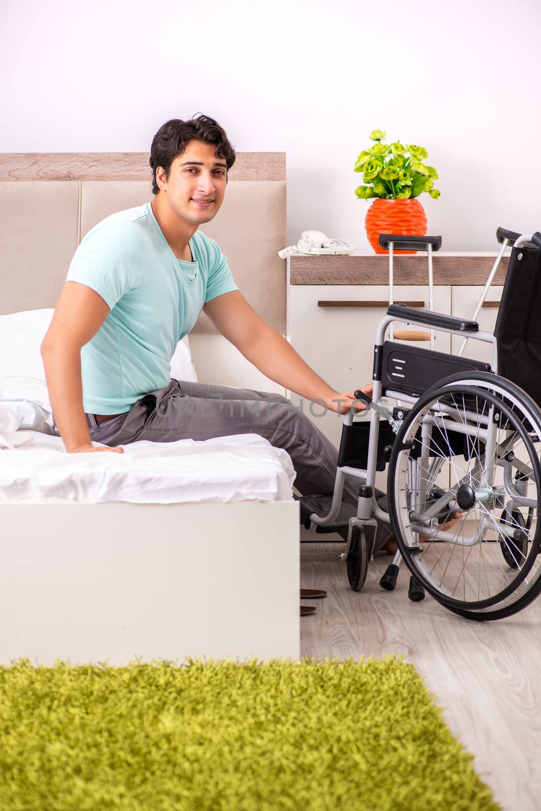 Young handsome disabled man recovering at home 
