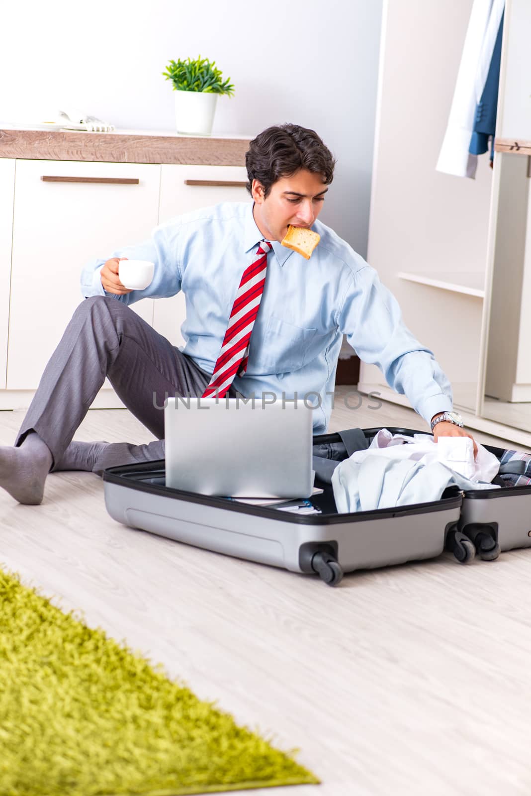 Young handsome businessman preparing for trip