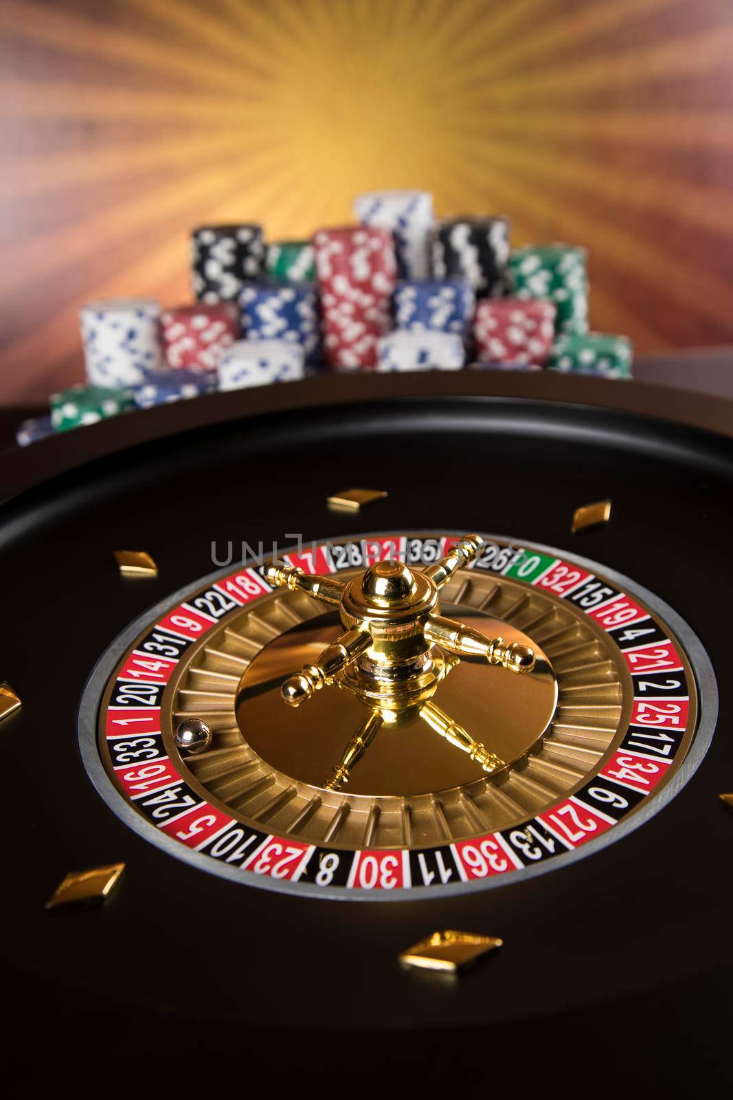 Poker Chips, Roulette wheel in motion, casino background  by JanPietruszka