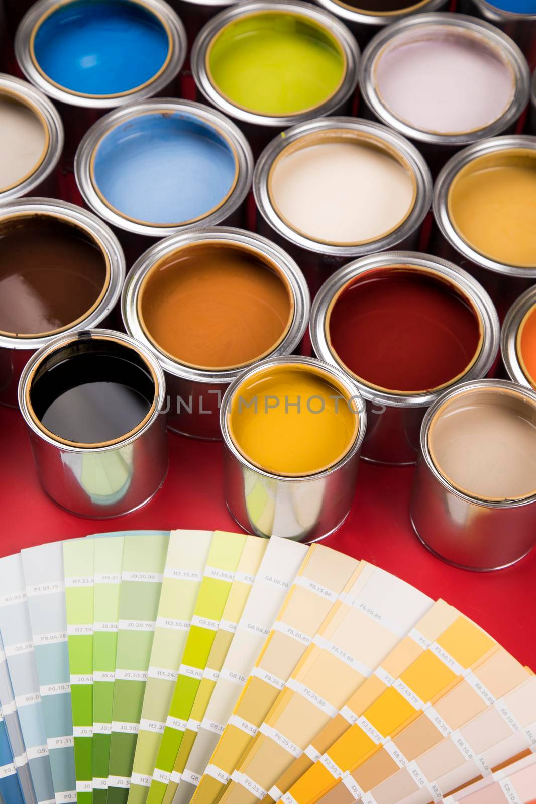 Tin cans with paint, brushes and bright palette of colors
