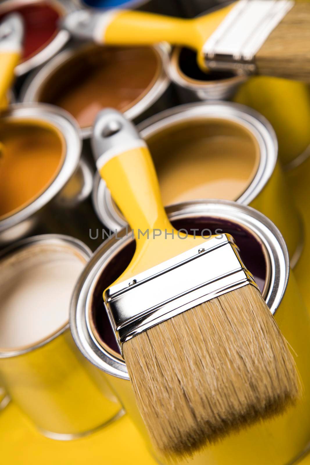 Metal tin cans with color paint and paintbrush