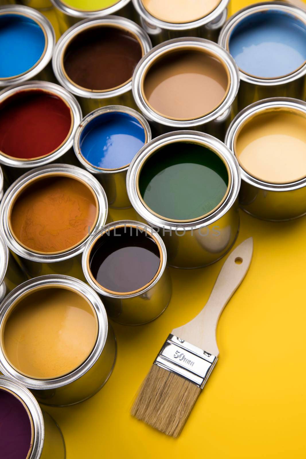 Tin cans with paint, brushes and bright palette of colors