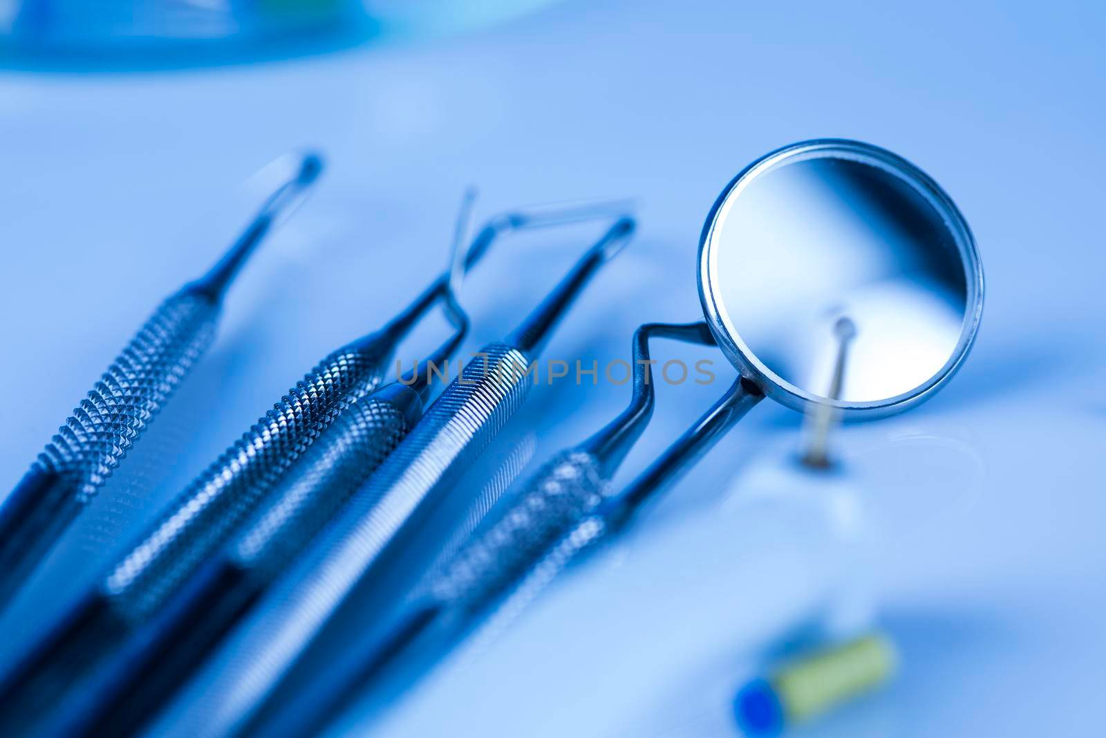 Dentist equipment on blue background by JanPietruszka