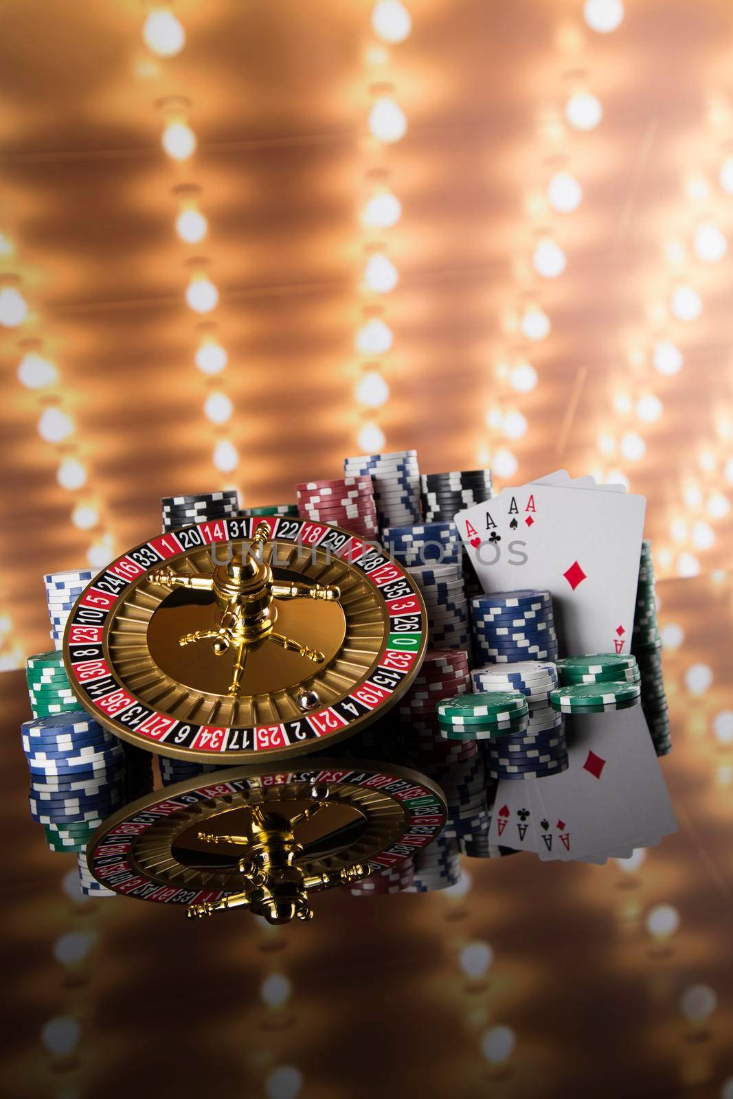 Poker Chips on gaming table, roulette wheel in motion, casino background