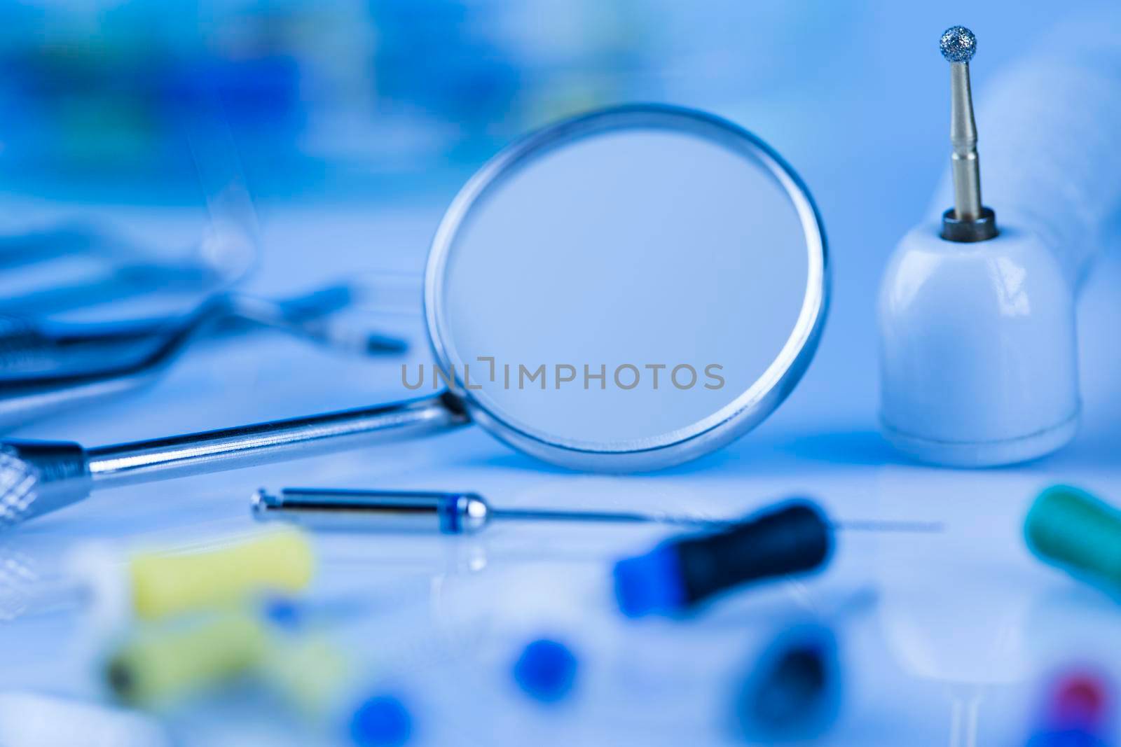 Dentist equipment on blue background by JanPietruszka