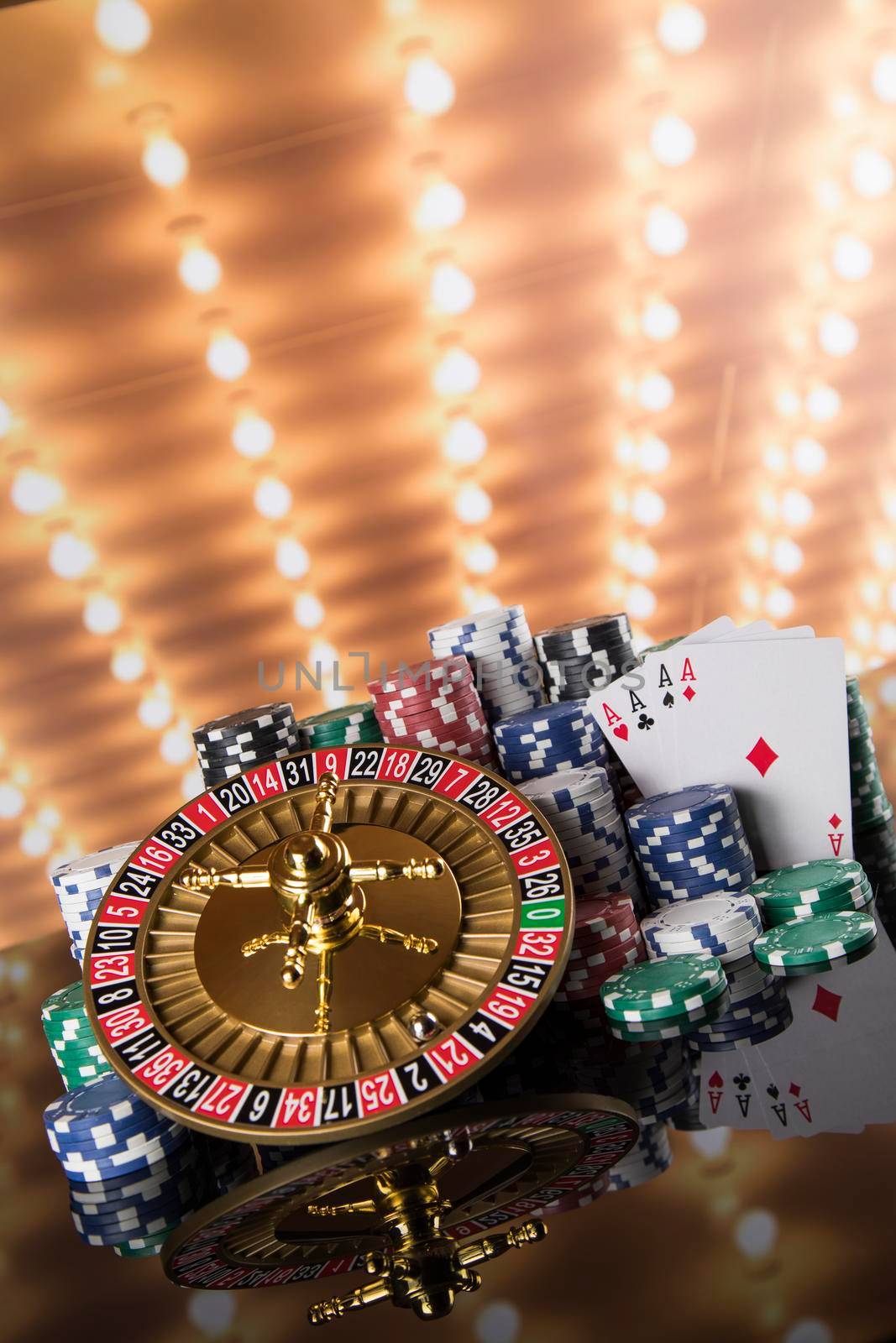 Poker Chips, Roulette wheel in motion, casino background  by JanPietruszka