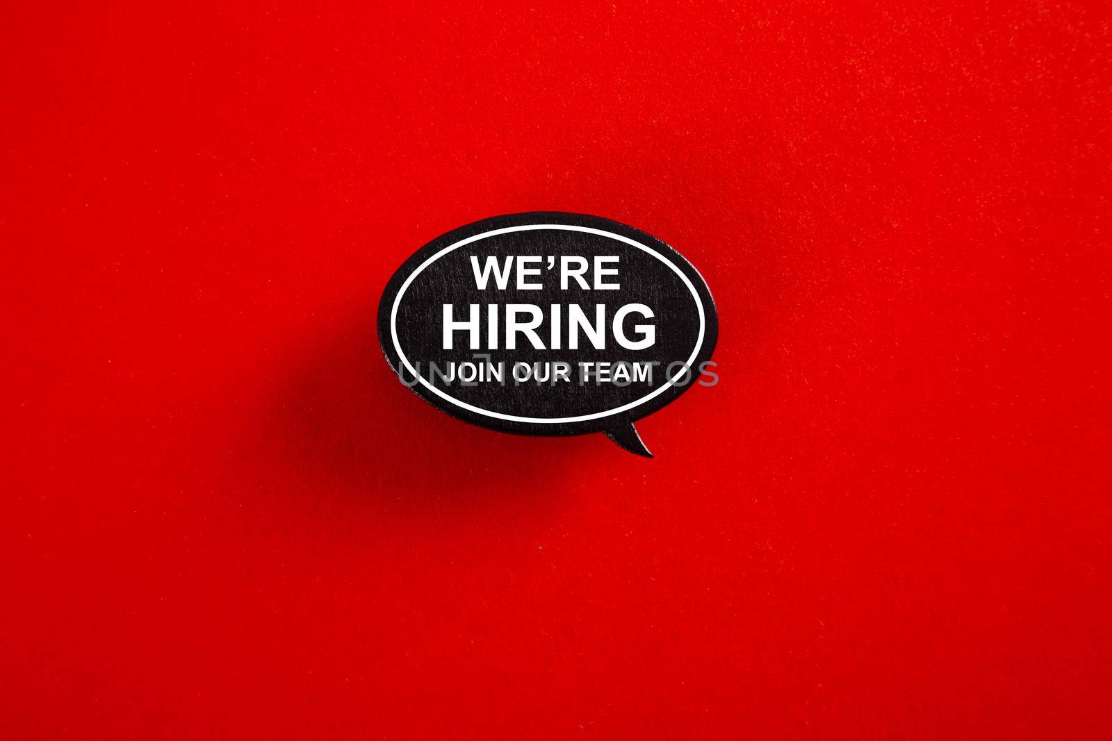 WE'RE HIRING in speech bubble isolated on red paper background. by tehcheesiong