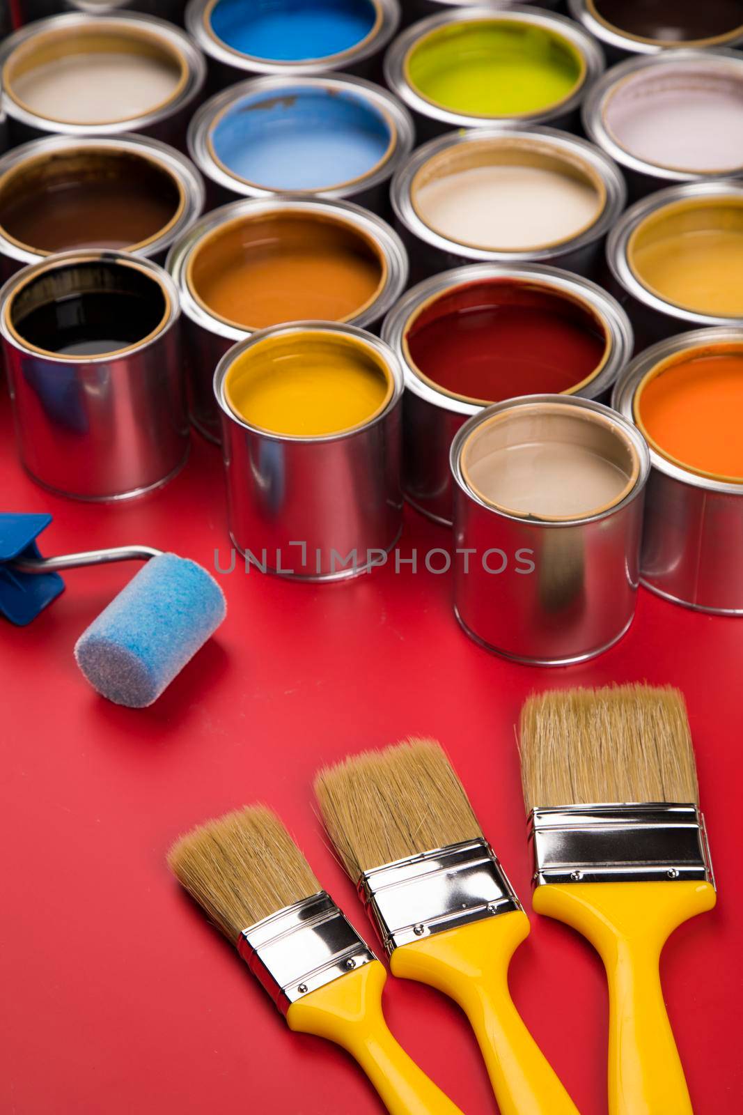 Paintbrush on cans with color by JanPietruszka