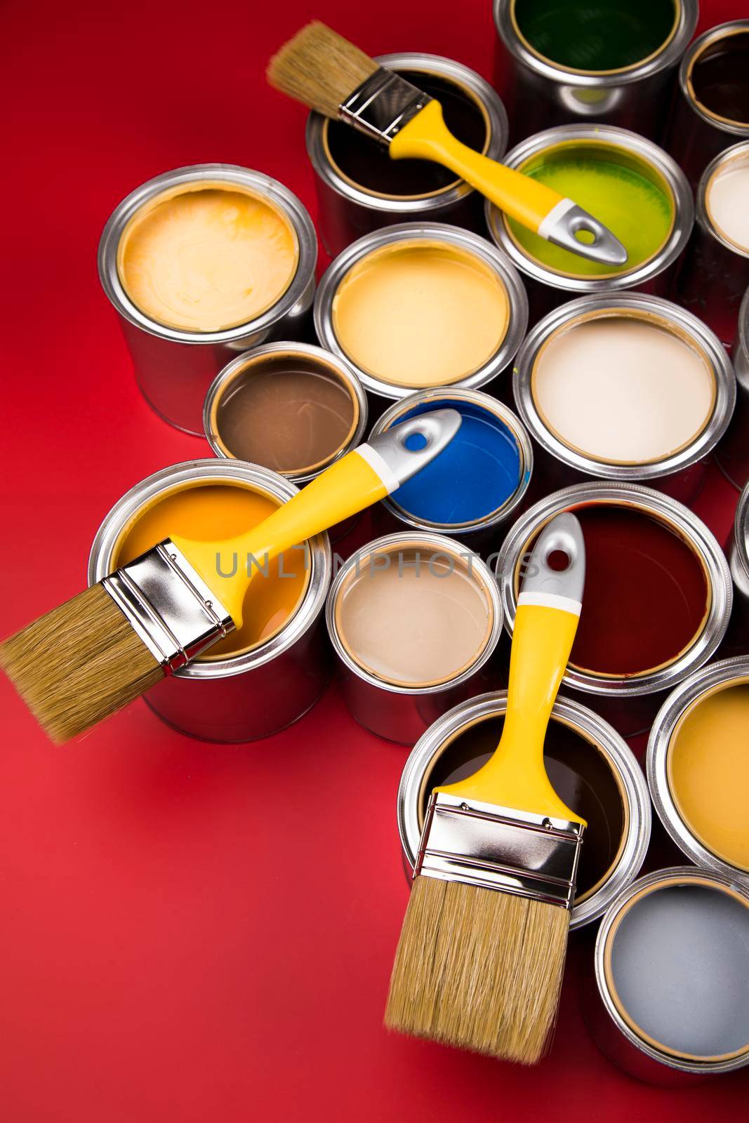 Tin cans with paint, brushes and bright palette of colors