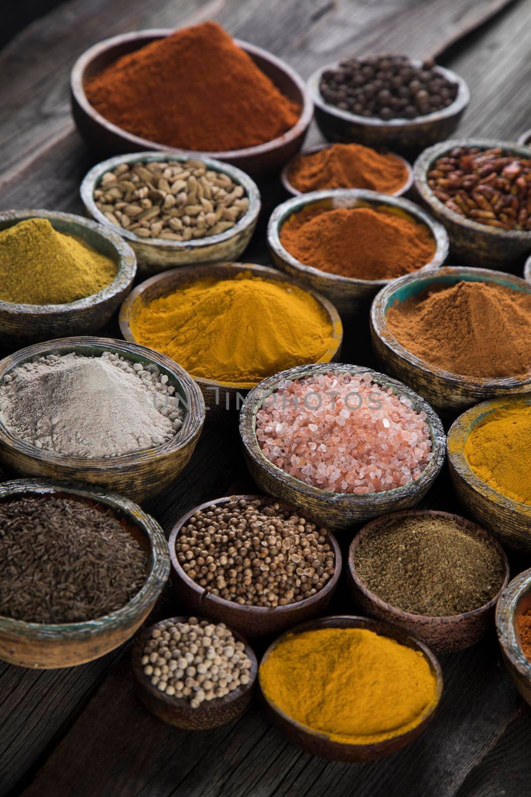 Spices and herbs in wooden bowl Colorful spices