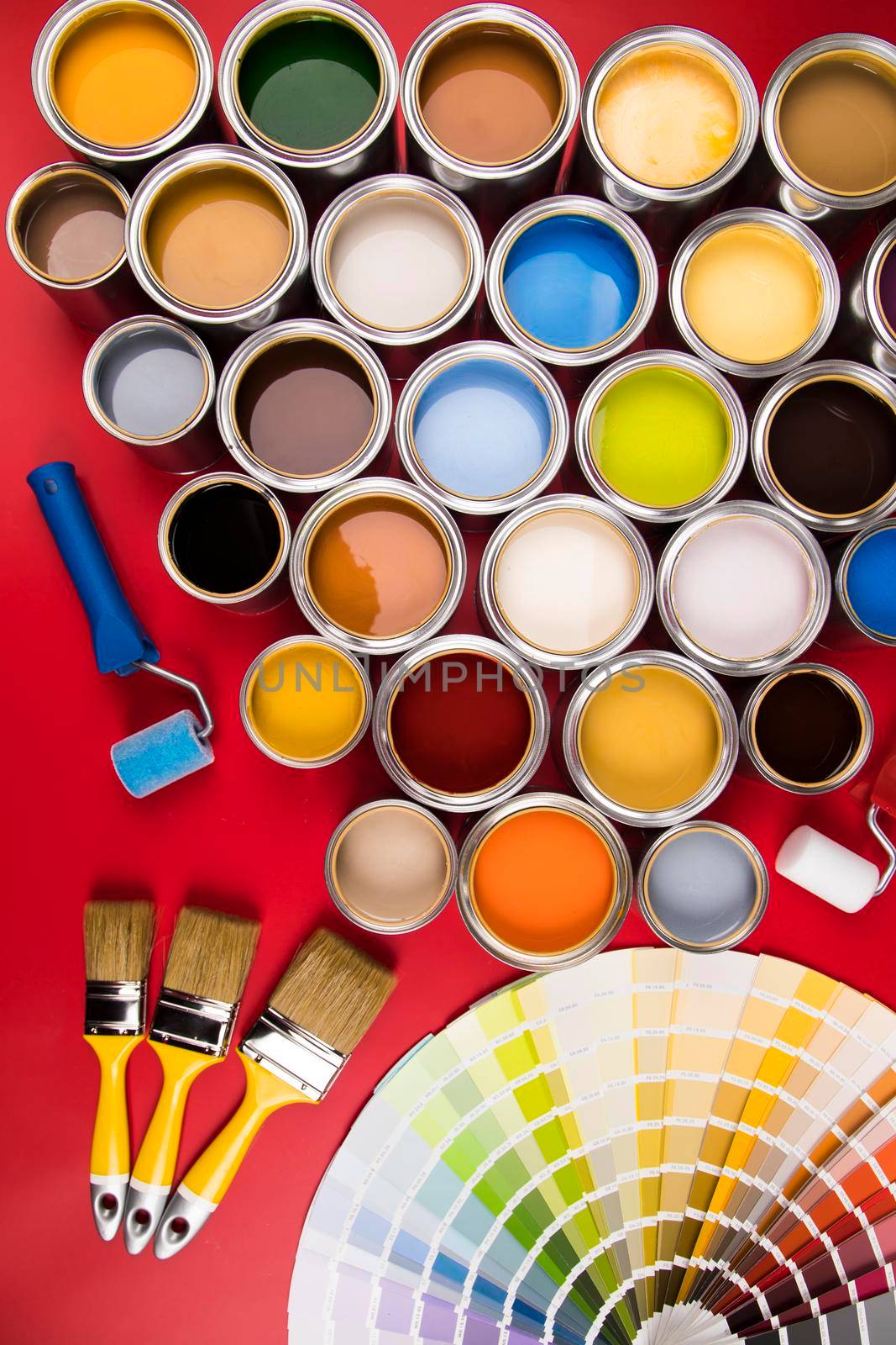 Paintbrush on cans with color by JanPietruszka