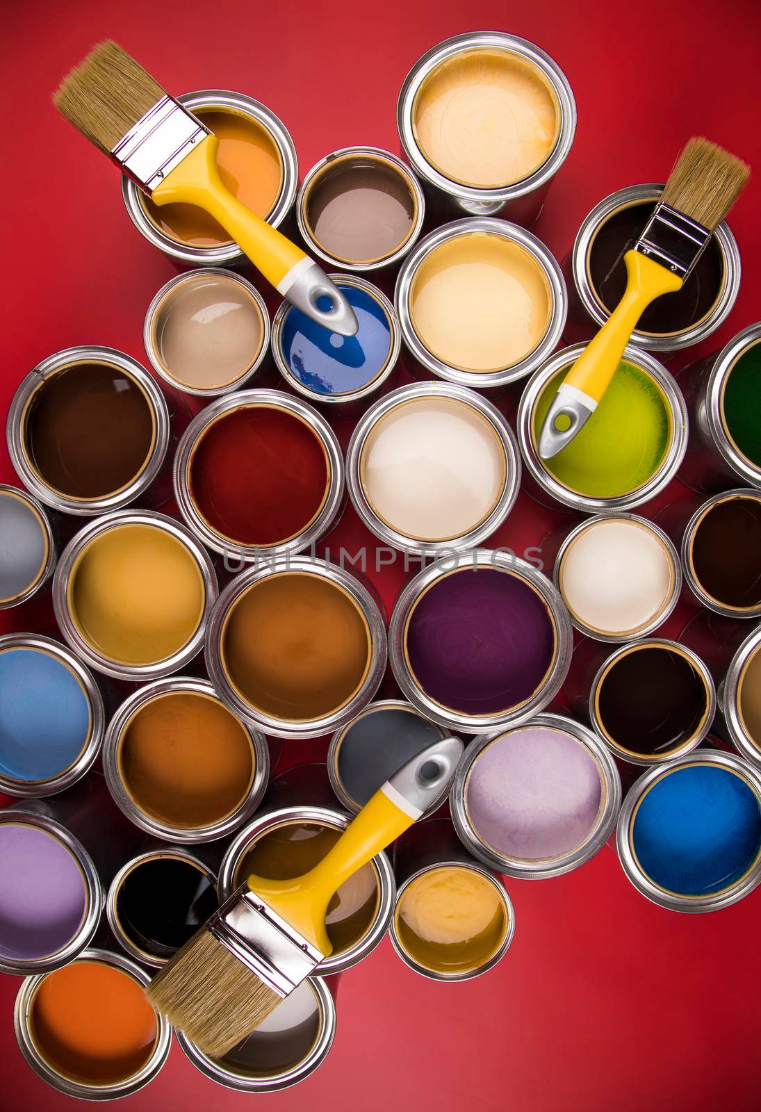 Paintbrush on cans with color