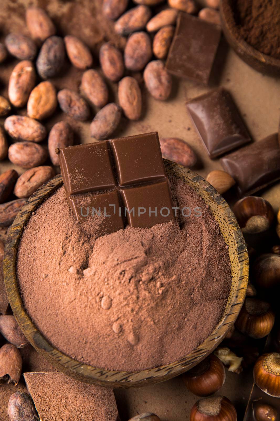 Dark homemade chocolate bars and cocoa pod on wooden