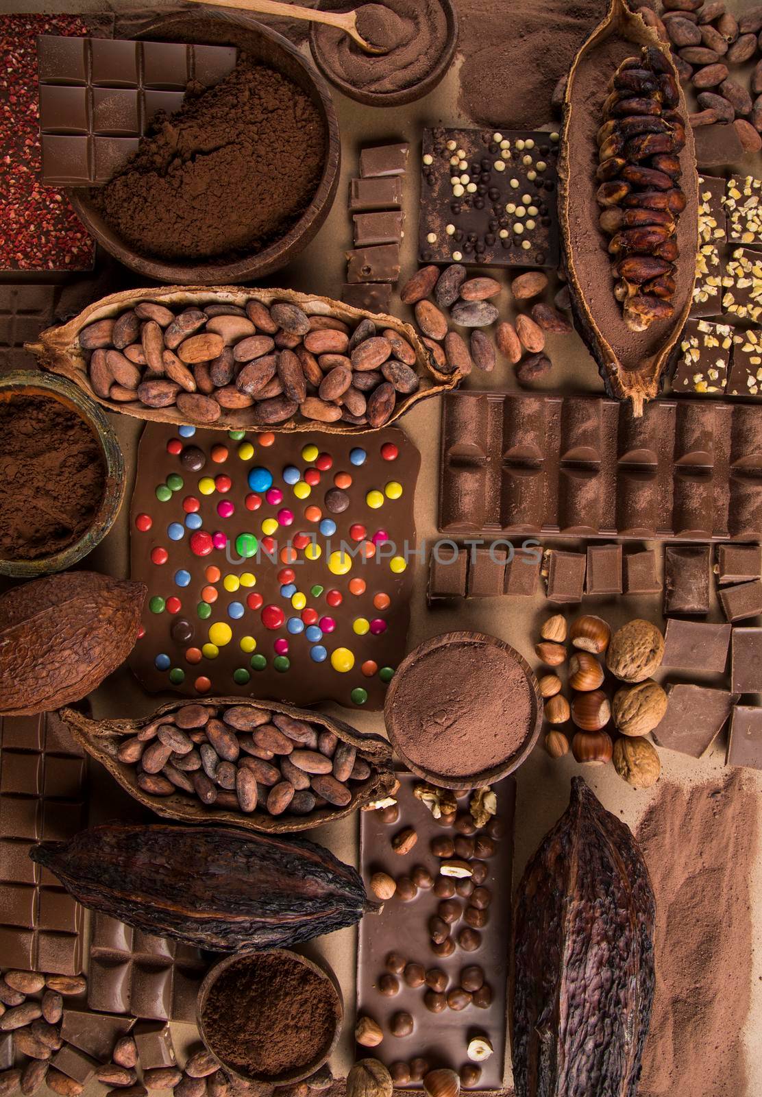 Dark homemade chocolate bars and cocoa pod on wooden