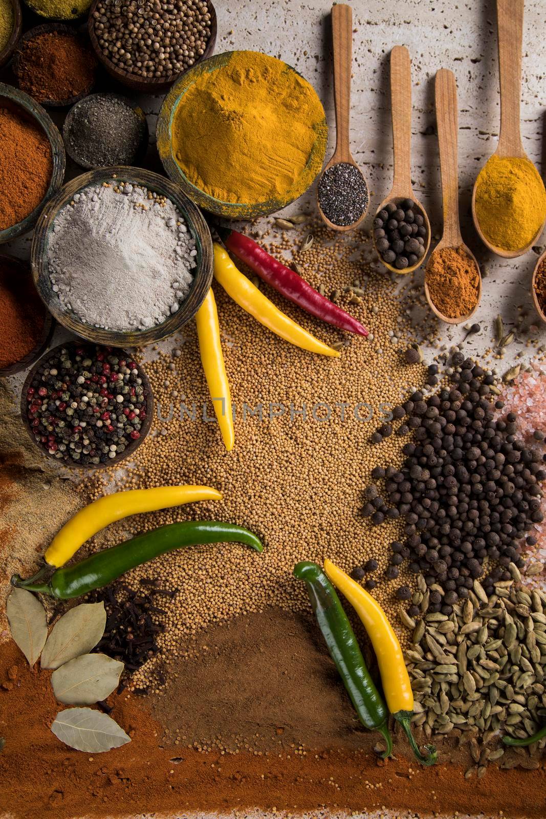 Variety of spices and herbs on kitchen table by JanPietruszka