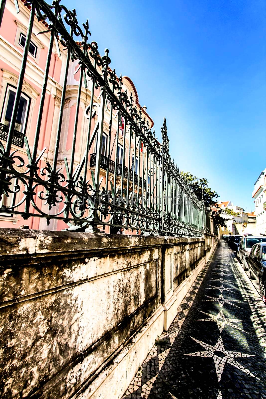 Colorful streets with majestic facades, windows and balconies of Lisbon city in Portugal on a sunny day