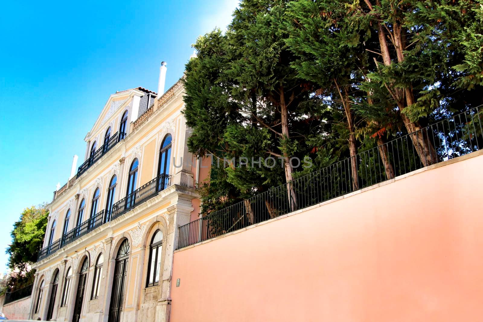 Colorful streets with majestic facades, windows and balconies of Lisbon city in Portugal on a sunny day