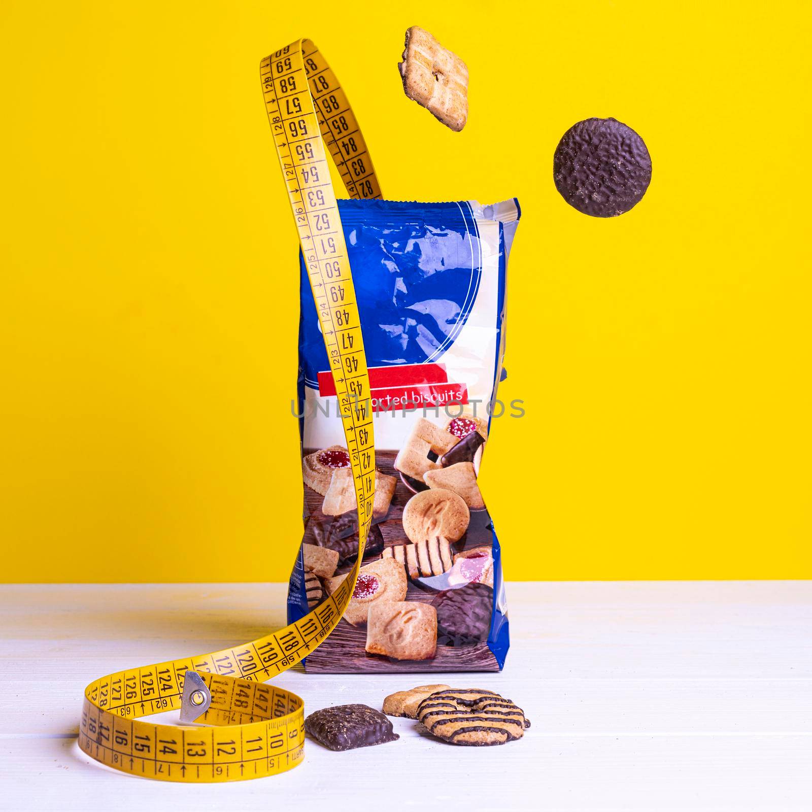 a tape measure between some cookies on a colored surface.