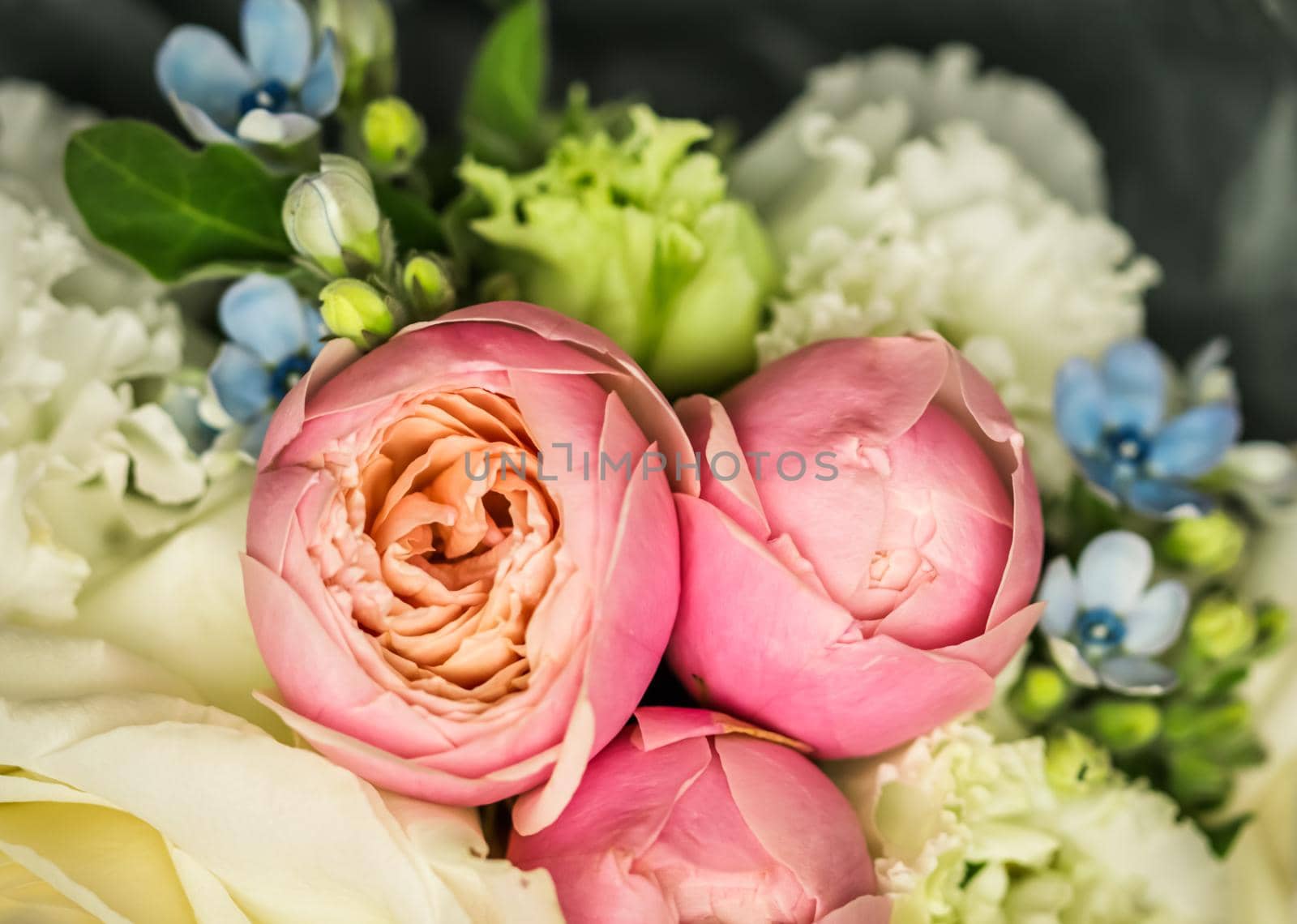 Beautiful flower bouquet arrangement close up in pastel colors. Decoration of roses and decorative plants, selective focus