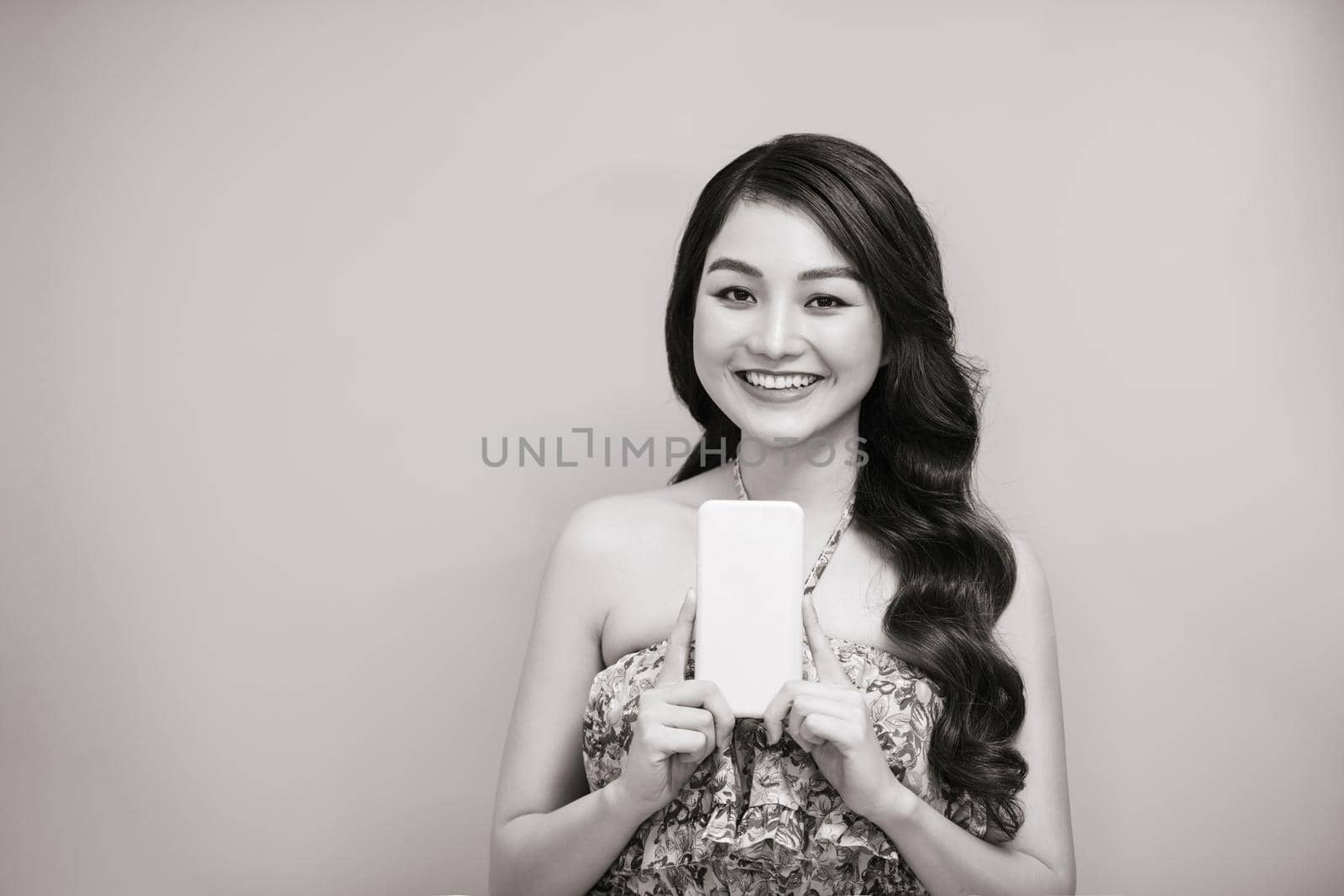 Beautiful happy young woman using mobile phone. Black and white photo by makidotvn