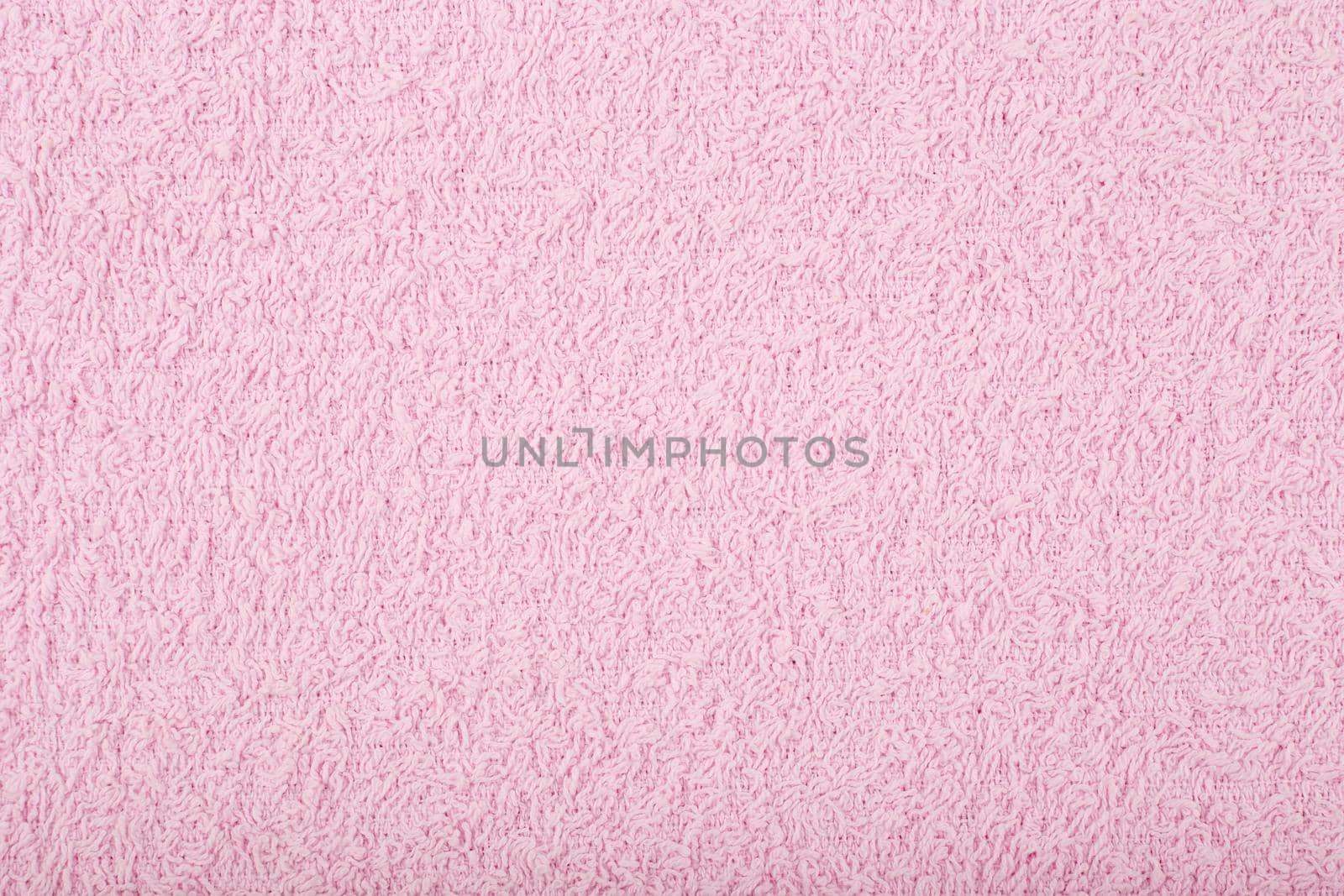 Purple fuzzy towel background. Fleecy fabric close up with space for text. Cozy material for bathroom towels or bathrobe