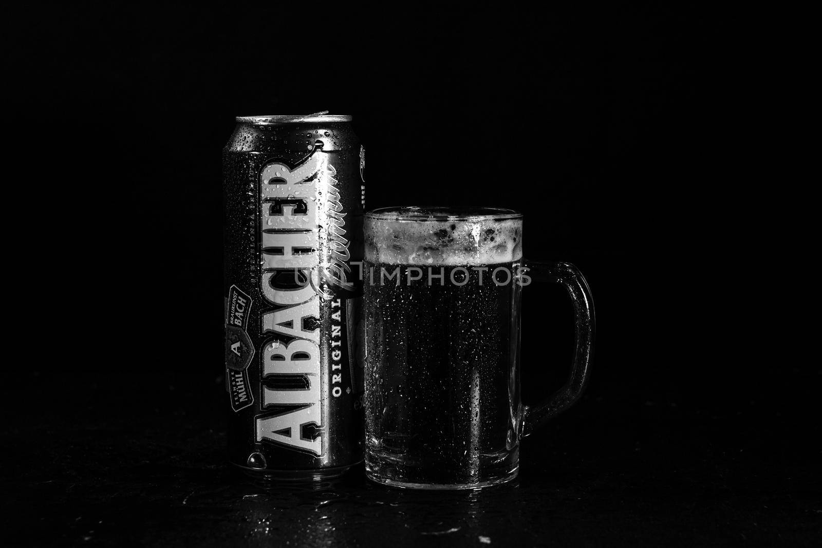 Can of Albacher beer and beer glass on dark background. Illustrative editorial photo shot in Bucharest, Romania, 2021 by vladispas