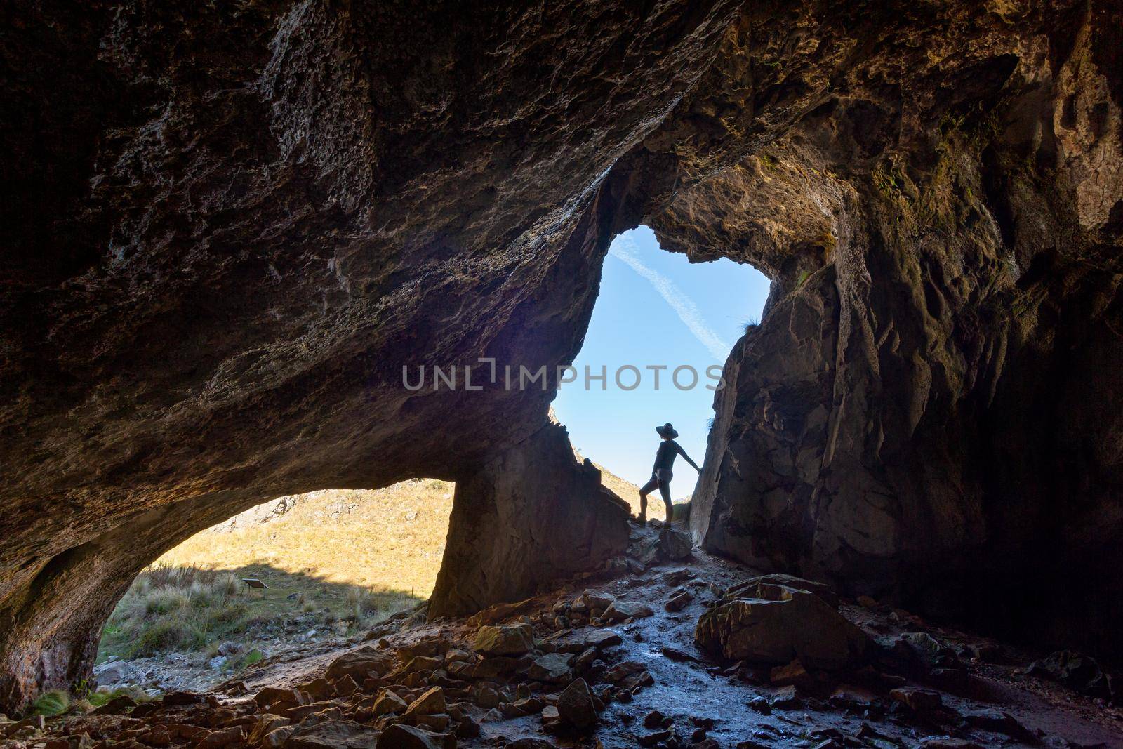 Female hiker exploring caves by lovleah