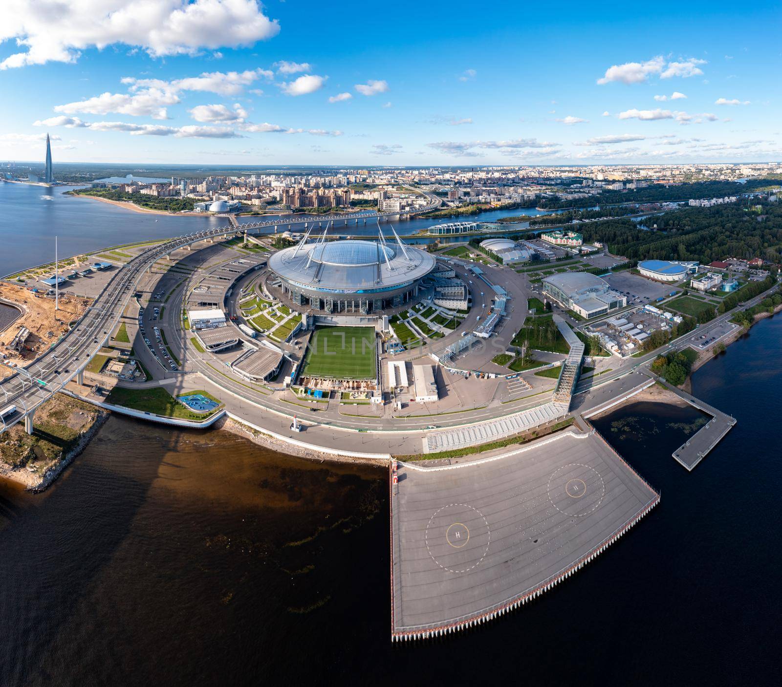 Russia, St.Petersburg, 01 September 2020: Drone point of view of new stadium Gazprom Arena, Euro 2020, retractable soccer field, skyscraper Lakhta center on background, clear weather, helipad. High quality photo