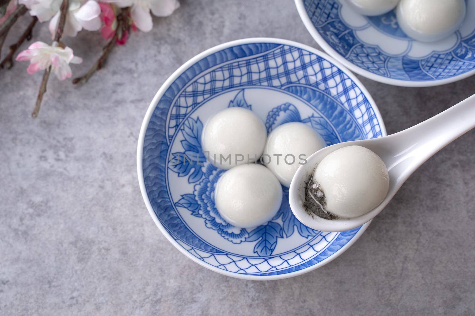 Top view of big tangyuan yuanxiao (glutinous rice dumpling balls) for lunar new year festival food, words on the golden coin means the Dynasty name it made.