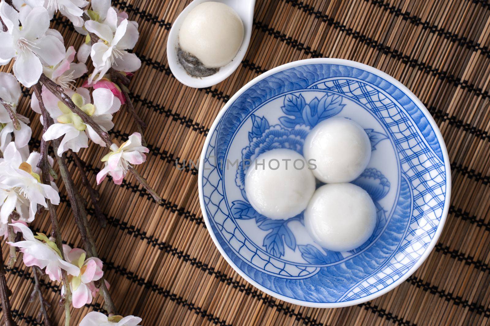 Top view of big tangyuan yuanxiao (glutinous rice dumpling balls) for lunar new year festival food, words on the golden coin means the Dynasty name it made.