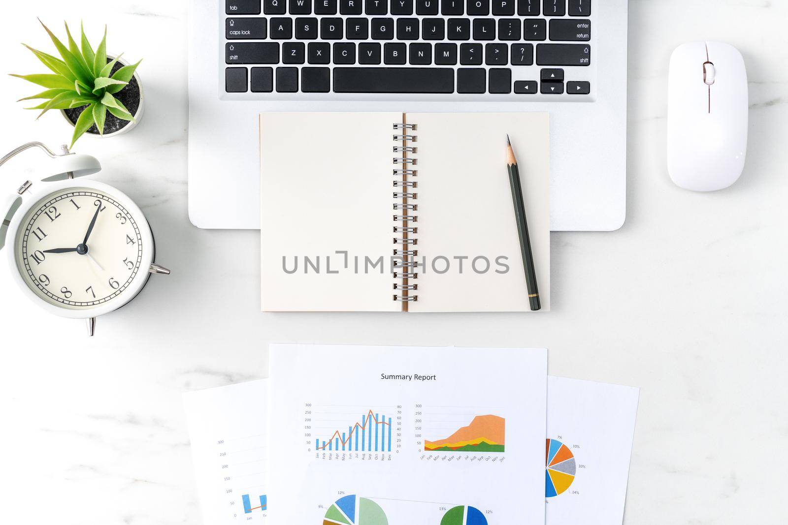 Top view of office table desk work concept with blank notebook, report, alarm clock on marble white background, concept of timing management and schedule planning.