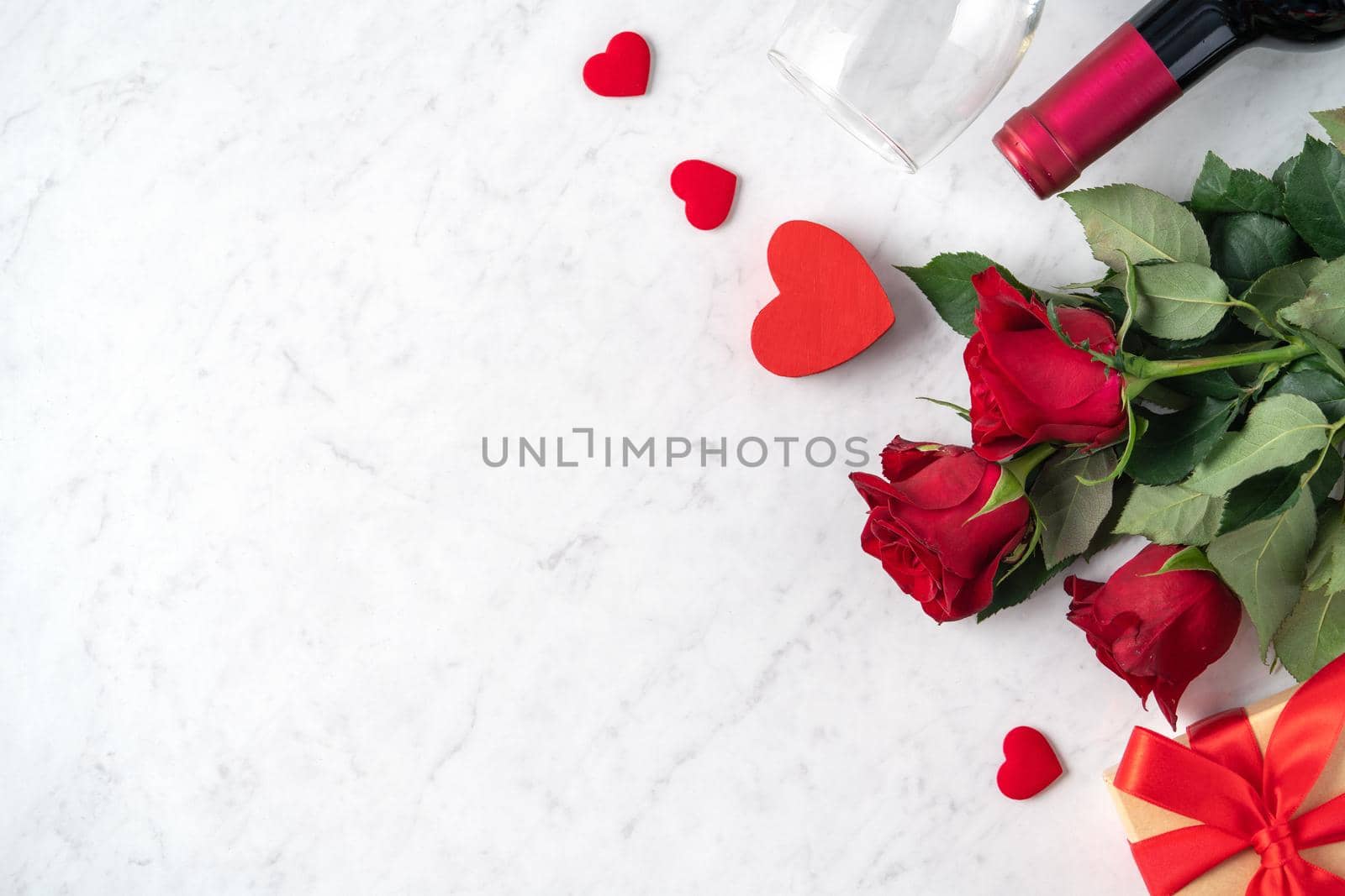 Top view of Valentine day gift with rose and wine, festive design concept for special holiday dating meal.