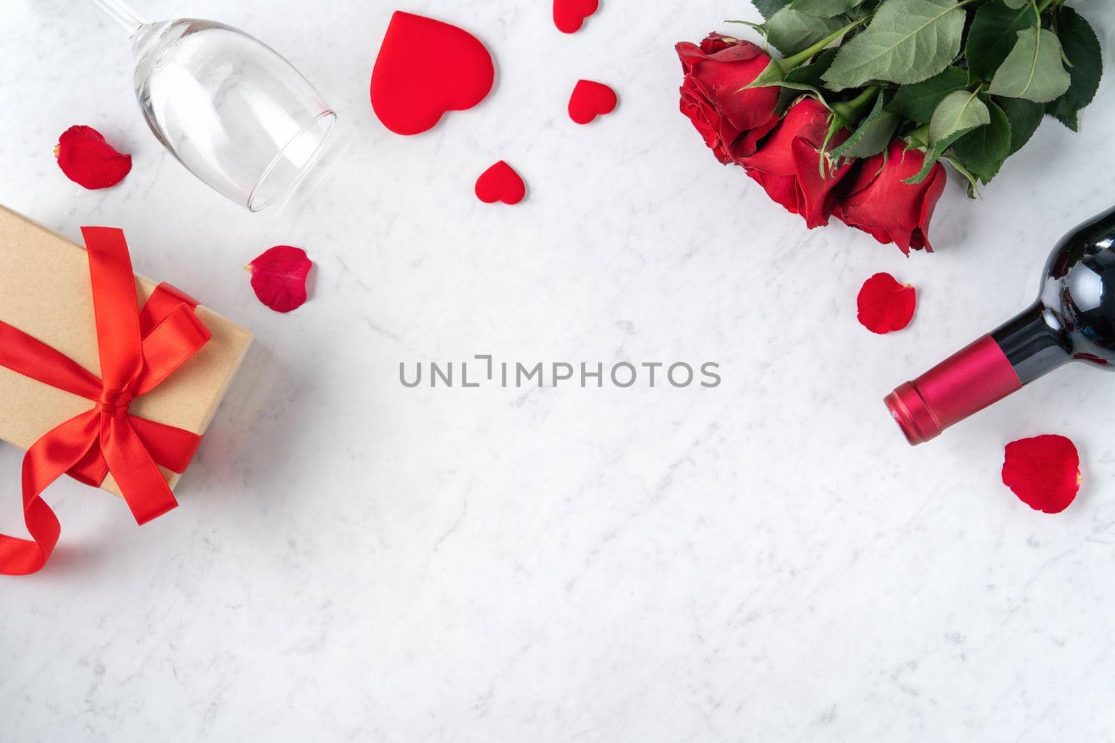 Top view of Valentine day gift with rose and wine, festive design concept for special holiday dating meal.