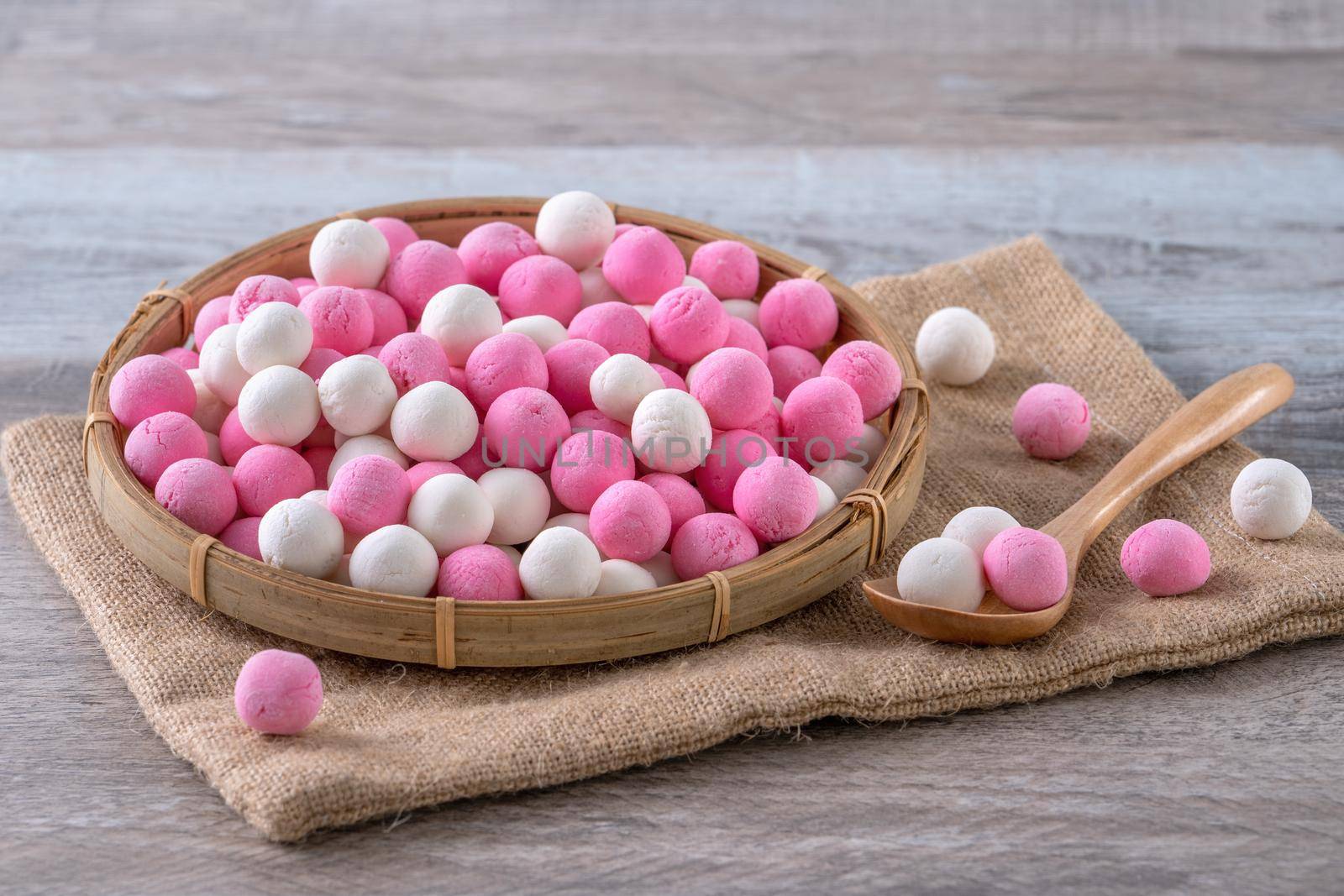 Raw red and white tangyuan on wooden table background for Winter solstice food. by ROMIXIMAGE