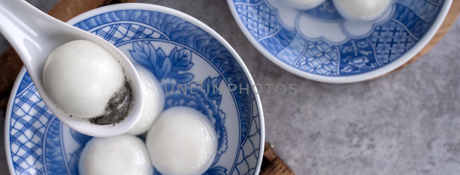 Top view of big tangyuan yuanxiao (glutinous rice dumpling balls) for lunar new year festival food, words on the golden coin means the Dynasty name it made.