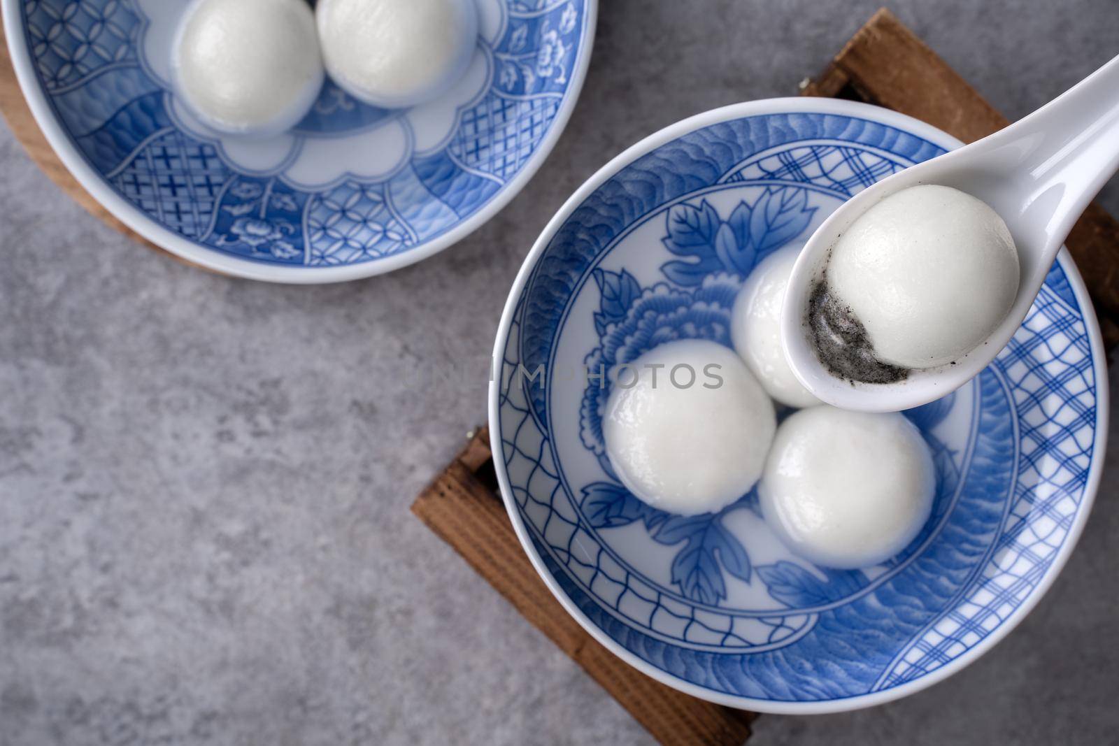 Top view of big tangyuan yuanxiao (glutinous rice dumpling balls) for lunar new year festival food, words on the golden coin means the Dynasty name it made.