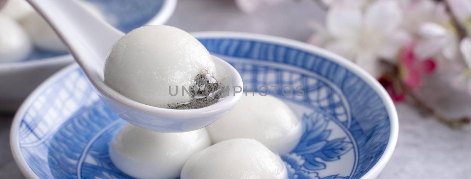Close up of big tangyuan yuanxiao (glutinous rice dumpling balls) for Winter Solstice festival food on gray table background.
