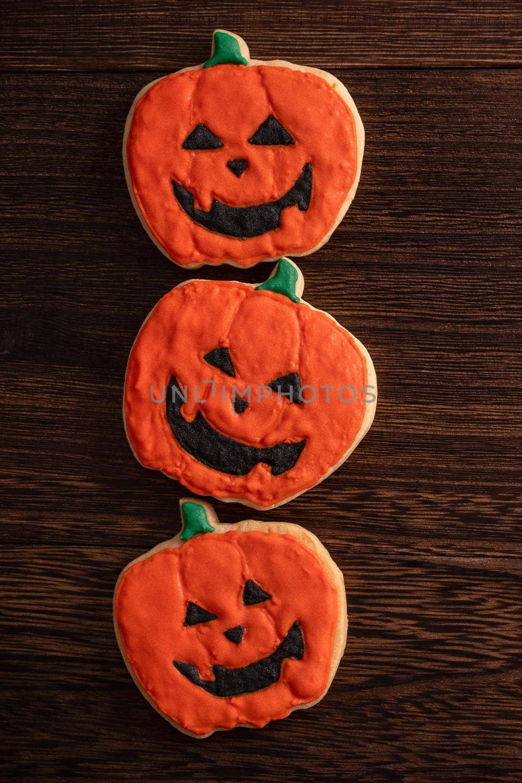 Top view of Halloween festive decorated icing gingerbread sugar cookies with copy space and flat lay layout.