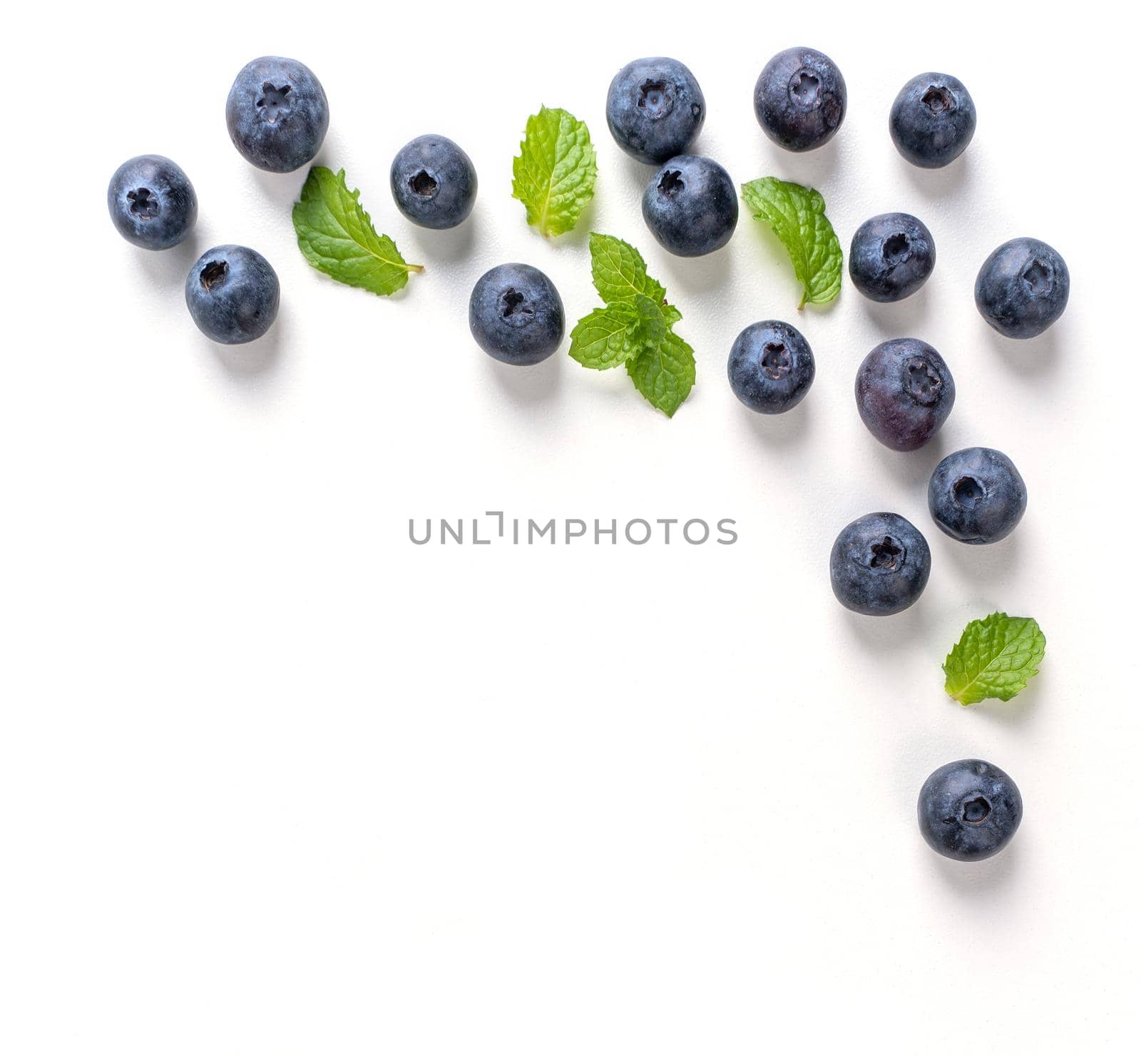 Blueberry fruit top view isolated on a white background, flat lay overhead layout with mint leaf, healthy design concept.
