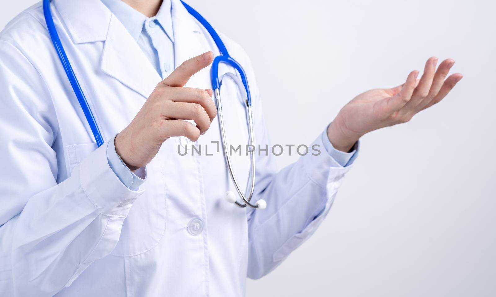 Female doctor body part with hand gesture, young woman physician with stethoscope isolated on white background, close up, cropped view, copy space