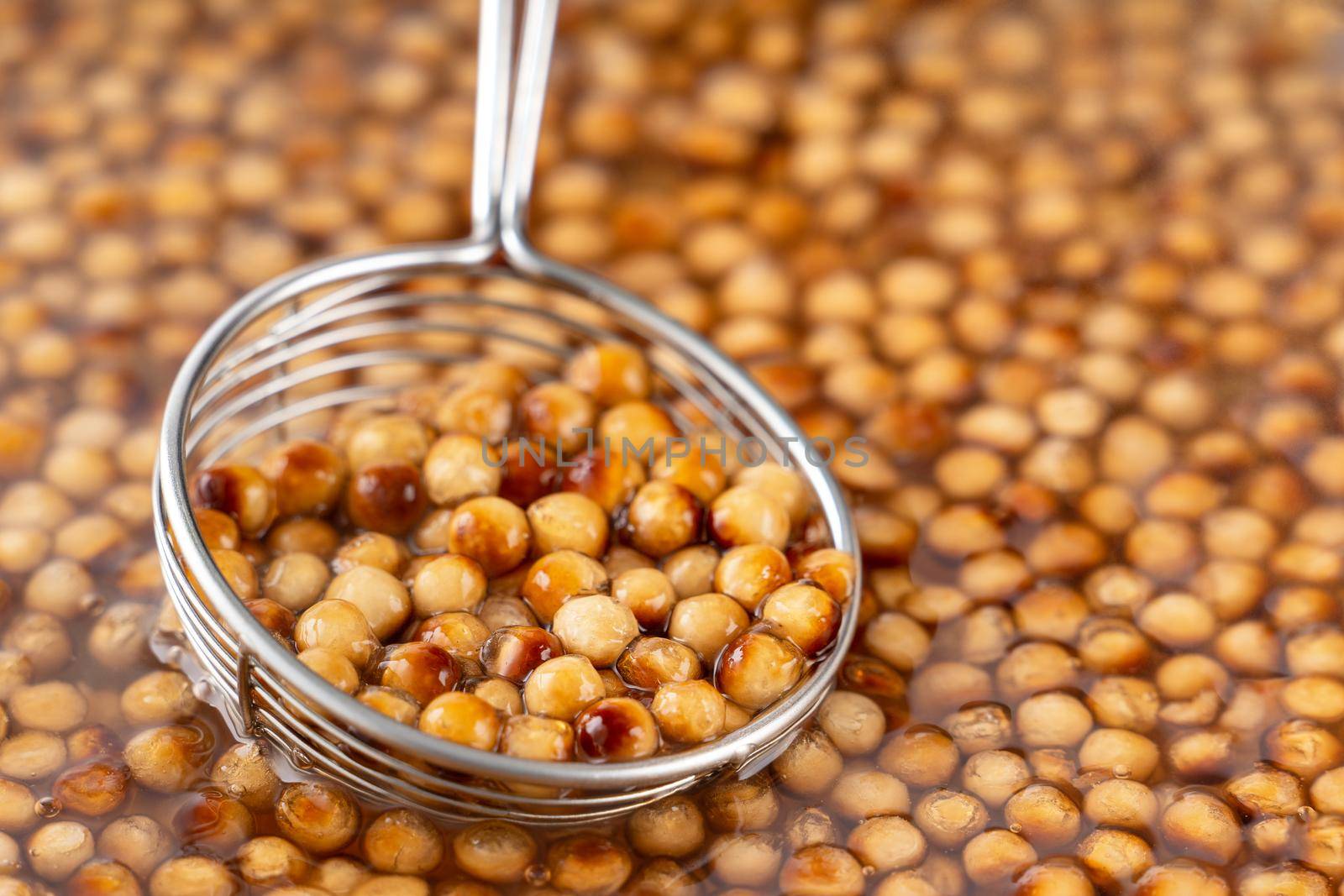Cooking, boiling brown sugar flavor tapioca pearl balls, ingredient of bubble tea, preparing food and drink, close up, recipe cookbook steps design concept.