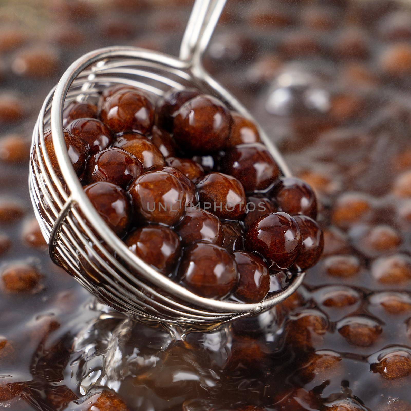 Cooking, boiling brown sugar flavor tapioca pearl balls, ingredient of bubble tea, preparing food and drink, close up, recipe cookbook steps design concept.
