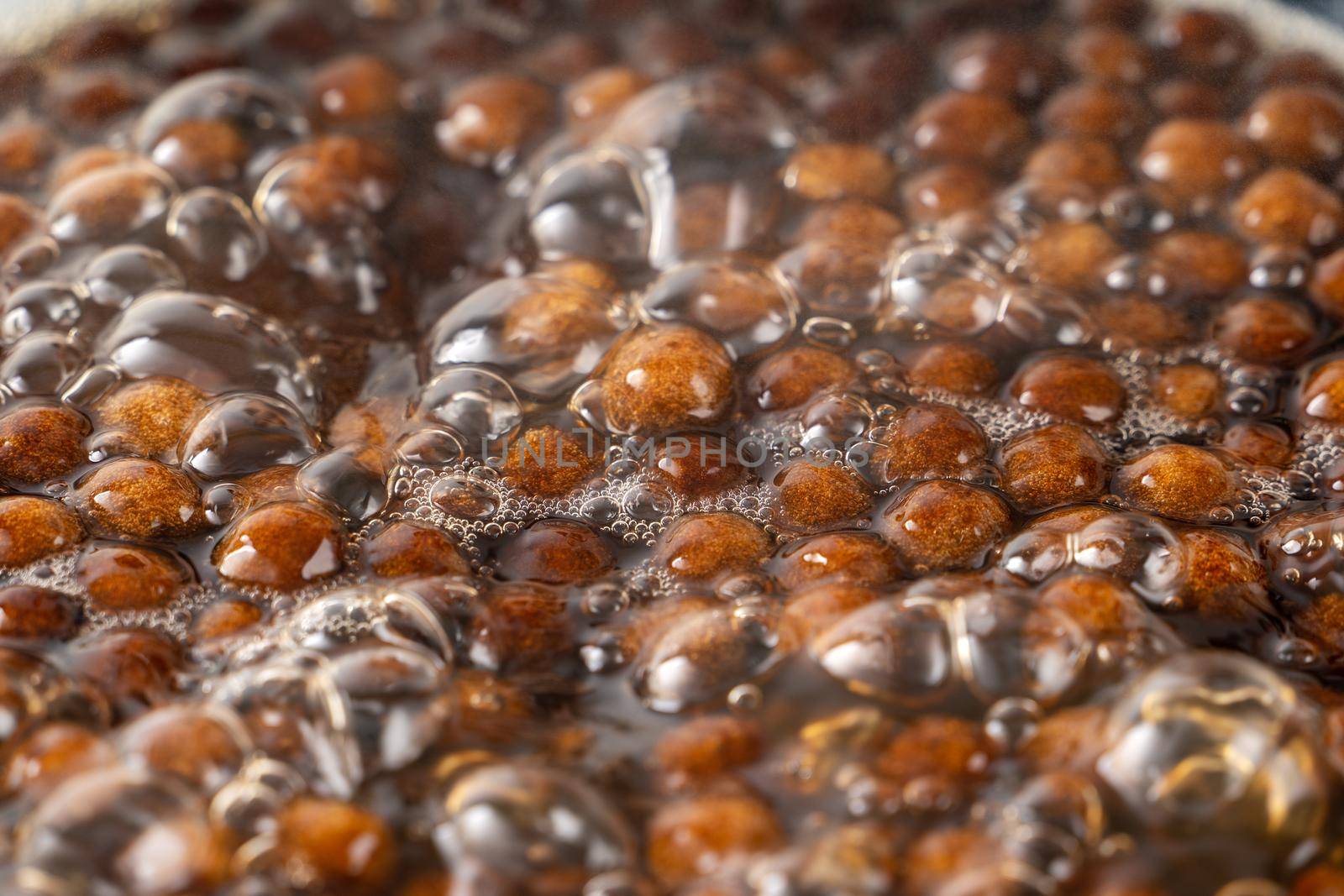 Cooking, boiling brown sugar flavor tapioca pearl balls, ingredient of bubble tea, preparing food and drink, close up, recipe cookbook steps design concept.