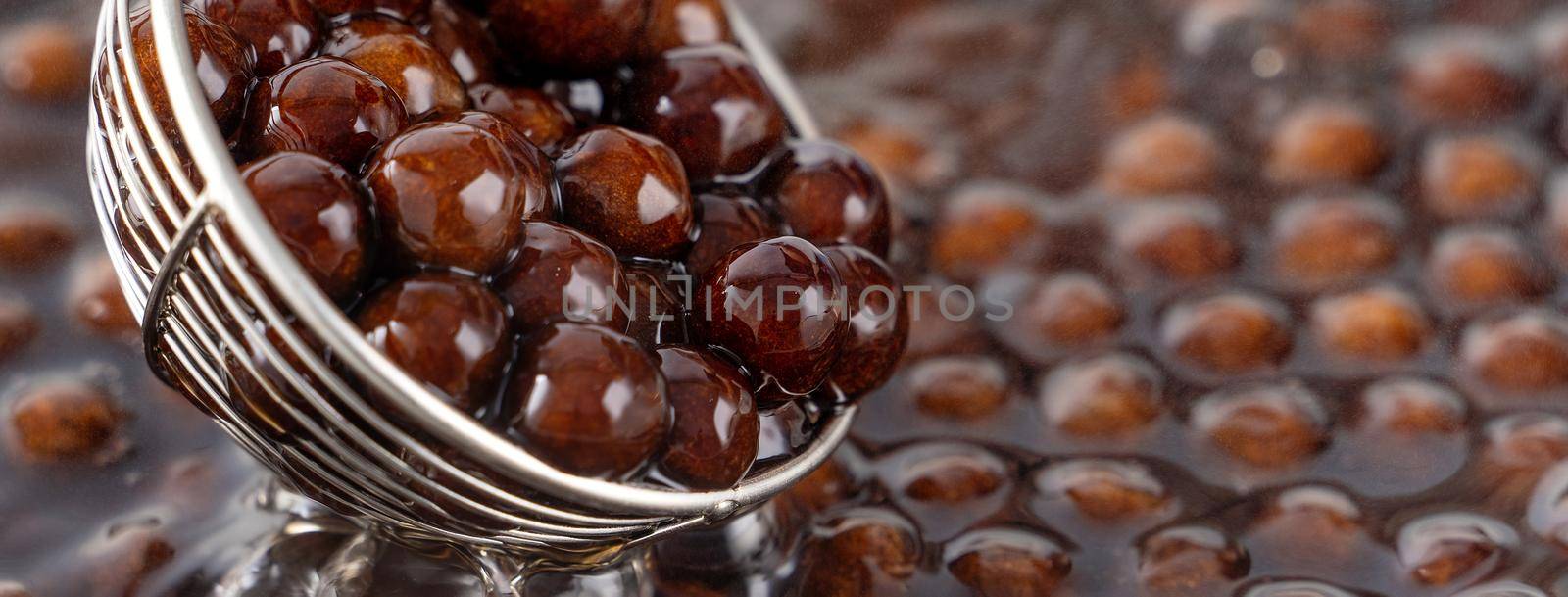 Cooking, boiling brown sugar flavor tapioca pearl balls, ingredient of bubble tea, preparing food and drink, close up, recipe cookbook steps design concept.