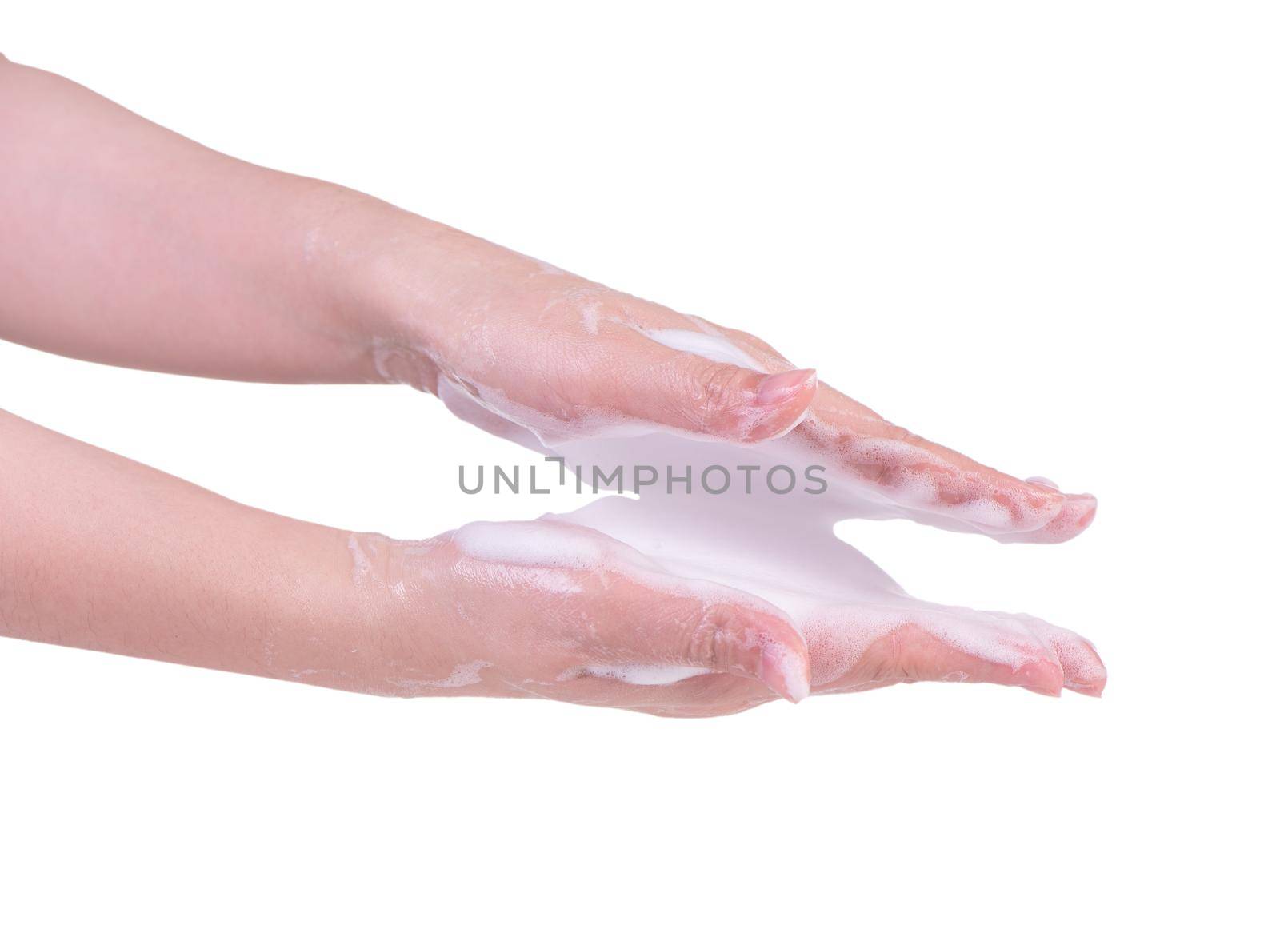 Washing hands isolated on white background. Asian young woman using liquid soap to wash hands, concept of protecting pandemic coronavirus, close up.